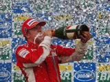 Kimi Raikkonen of Finland and Ferrari celebrates on the podium after winning the race and the F1 World Championship at the Brazilian Grand Prix on October 21, 2007