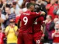 Sadio Mane celebrates with Roberto Firmino after scoring during the Premier League game between Liverpool and West Ham United on August 12, 2018