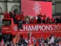 Manchester United players and staff celebrate on the bus during the winners parade on May 13, 2013