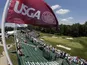 Spectators watch golfers on the 17th green during practice for the U.S. Open golf tournament at Merion Golf Club on June 12, 2013