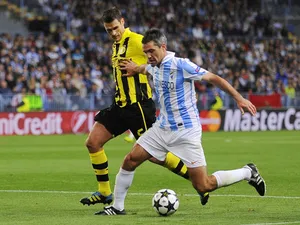 Malaga's Jeremy Toulalan fends off a challenge during his side's match against Dortmund on April 3, 2013