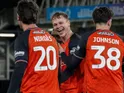Luton Town's Mads Andersen celebrates with Lasse Nordas and Joe Johnson on December 2, 2025