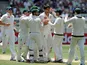 Australia's Mitchell Johnson is congratulated by his team after bowling out Sri Lanka's Angleo Mathews on December 28, 2012