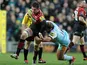 Northampton Saints' Paul Doran-Jones is tackled by Saracens' Ernst Joubert on December 30, 2012