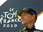 Lance Armstrong in front of a Tour de France brand board in 2010