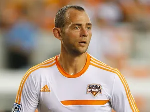 Brad Davis of the Houston Dynamo works out on the field before the game against the Chicago Fire at BBVA Compass Stadium on July 27, 2013
