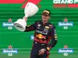 Red Bull's Max Verstappen celebrates with a trophy on the on the podium after winning the Dutch Grand Prix on August 27, 2023