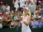 Alison Riske of the U.S. celebrates winning her fourth round match against Australia's Ashleigh Barty on July 8, 2019