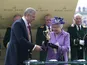 The Queen receives the Gold Cup after her horse Estimate won at Ascot on June 20, 2013
