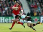 Munster's Dennis Hurley is tackled by Harlequins' George Lowe on April 7, 2013