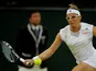 Kirsten Flipkens returns the ball to opponent Petra Kvitova during their Wimbledon quarter final match on July 2, 2013
