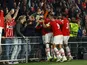 PSV Eindhoven's Jordan Teze celebrates scoring their second goal with teammates and fans on October 4, 2023