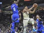 Milwaukee Bucks forward Giannis Antetokounmpo (34) takes a shot between Orlando Magic guard Terrence Ross (8) and forward Aaron Gordon (00) in the second quarter at Fiserv Forum on December 10, 2019