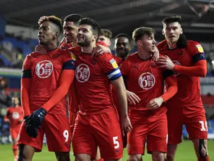 Jamal Lowe leads Wigan's survival fight with victory over relegation rivals Huddersfield