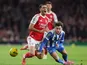 Arsenal midfielder Mikel Merino tackled by Brighton's Maxim De Cuyper