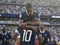 Michael Olise leaps into the arms of Kylian Mbappe te celebrate France goal
