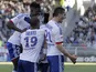 Lyon players celebrate following a goal in their match against Toulouse on April 14, 2013