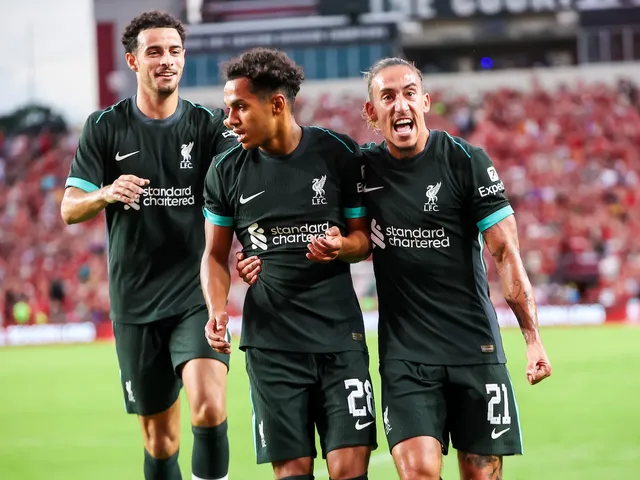 Liverpool midfielder Fabio Carvalho scores celebrates a goal against Manchester United with teammate defender Kostas Tsimikas (21) and midfielder Curtis Jones (17) on August 4, 2024