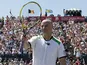 Former Tennis star Andre Agassi waves to the crowd during an exhibition match on July 10, 2011