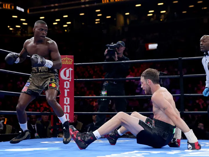 Lee survives knockdowns to draw with Quillin