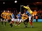 Cambridge United's Dimitar Mitov in action with Portsmouth's Sean Raggett on January 3, 2022