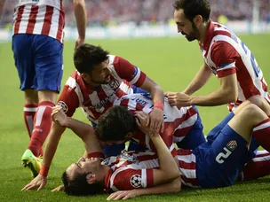 Godin gives Atletico interval lead