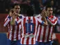 Athletico Madrid striker Radamel Falcao is congratulated following a goal against Valencia on March 31, 2013