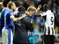 Players from both sides check on Phil Neville after he cut his head during the game between Everton and Newcastle on January 2, 2013