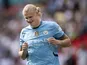 Erling Haaland of Manchester City smiles after scoring his penalty during the shoot out during the 2024 FA Community Shield match between Manchester United and Manchester City at Wembley Stadium on August 10, 2024