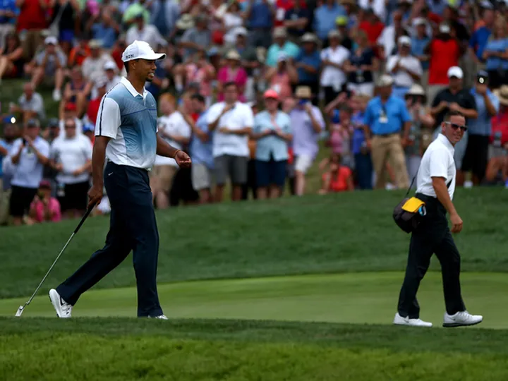 Woods parts with coach Foley