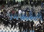 Riot police move in on Egyptian fans causing trouble during a game with Morocco on January 24, 2006
