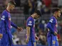 Barcelona's Gerard Pique, Yusuf Demir and Philippe Coutinho look dejected after the match on September 14, 2021