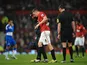 Man Utd defender Phil Jones leaves the field injured against Reading on February 18, 2013