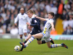 Leeds United's Samuel Byram slides in on Huddersfield Town's Paul Dixon during the Campionship clash on March 16, 2013