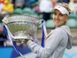 Russia's Elena Vesnina lifts the tournament trophy after winning the final match against USA's Jamie Hampton during the AEGON International on June 22, 2013