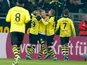 Borussia Dortmund's Marco Reus is congratulated by team mates after scoring the opener on December 8, 2012