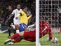 England's Joe Hart saves the ball after Brazil's Ronaldinho follows up his missed penalty in their side's match on February 6, 2013