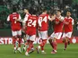 Arsenal players celebrate an own goal scored by Sporting Lisbon's Hidemasa Morita on March 9, 2023