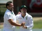 South Africa's Dean Elgar congratulates his team mates Jacques Kallis after dismissing New Zealand's Dean Brownlie on January 14, 2013