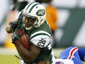 Running back Bilal Powell #29 of the New York Jets is tackled by defensive back Nickell Robey #37 defensive tackle Corbin Bryant #97 in the third quarter during a game at MetLife Stadium on September 22, 2013