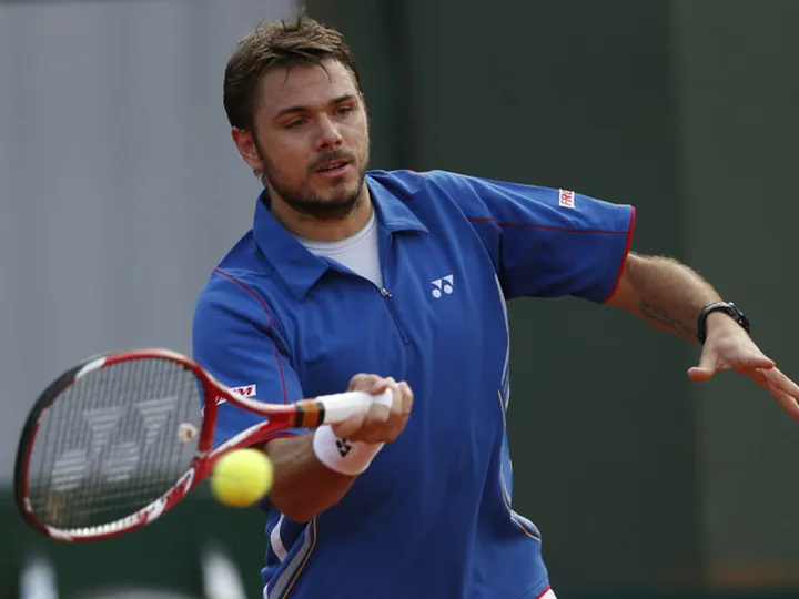 Wawrinka battles into round two