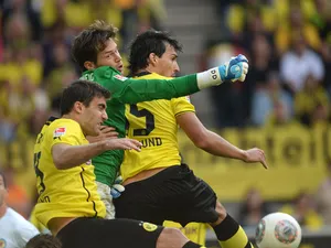 Braunschweig's goalkeeper Daniel Davari ,Dortmund's Greek defender Sokratis and Dortmund's defender Mats Hummels vie for the ball during the German first division Bundesliga football match Borussia Dortmund vs Eintracht Braunschweig in Dortmund, western G