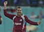 West Indies' Sunil Narine raises arms in jubilation after taking the wicket of Australia's Aaron Finch on February 8, 2013