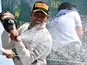 Mercedes AMG Petronas F1 Team's British driver Lewis Hamilton celebrates on the podium after winning the British Formula One Grand Prix at the Silverstone circuit in Silverstone on July 5, 2015